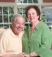 couple in front of window holding hands