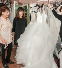 Ladies shopping looking at Wedding Dress