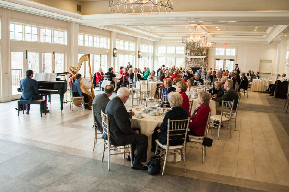 Vantage Club Members talk with harp cello and piano players