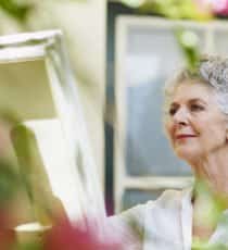senior woman in independent living community painting