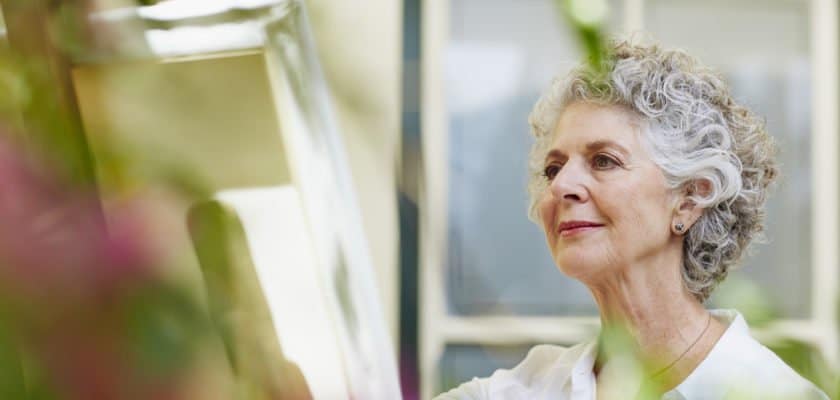 senior woman in independent living community painting