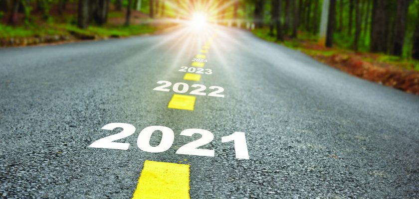 New year journey 2021 to 2024 on asphalt road surface with marking lines and sunlight