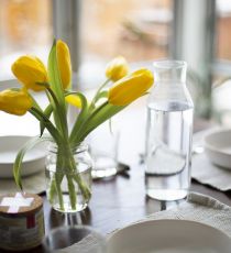 Yellow tulips on a dining table.