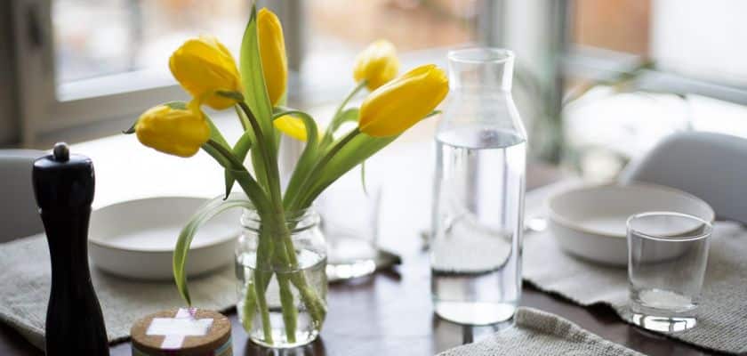 Yellow tulips on a dining table.