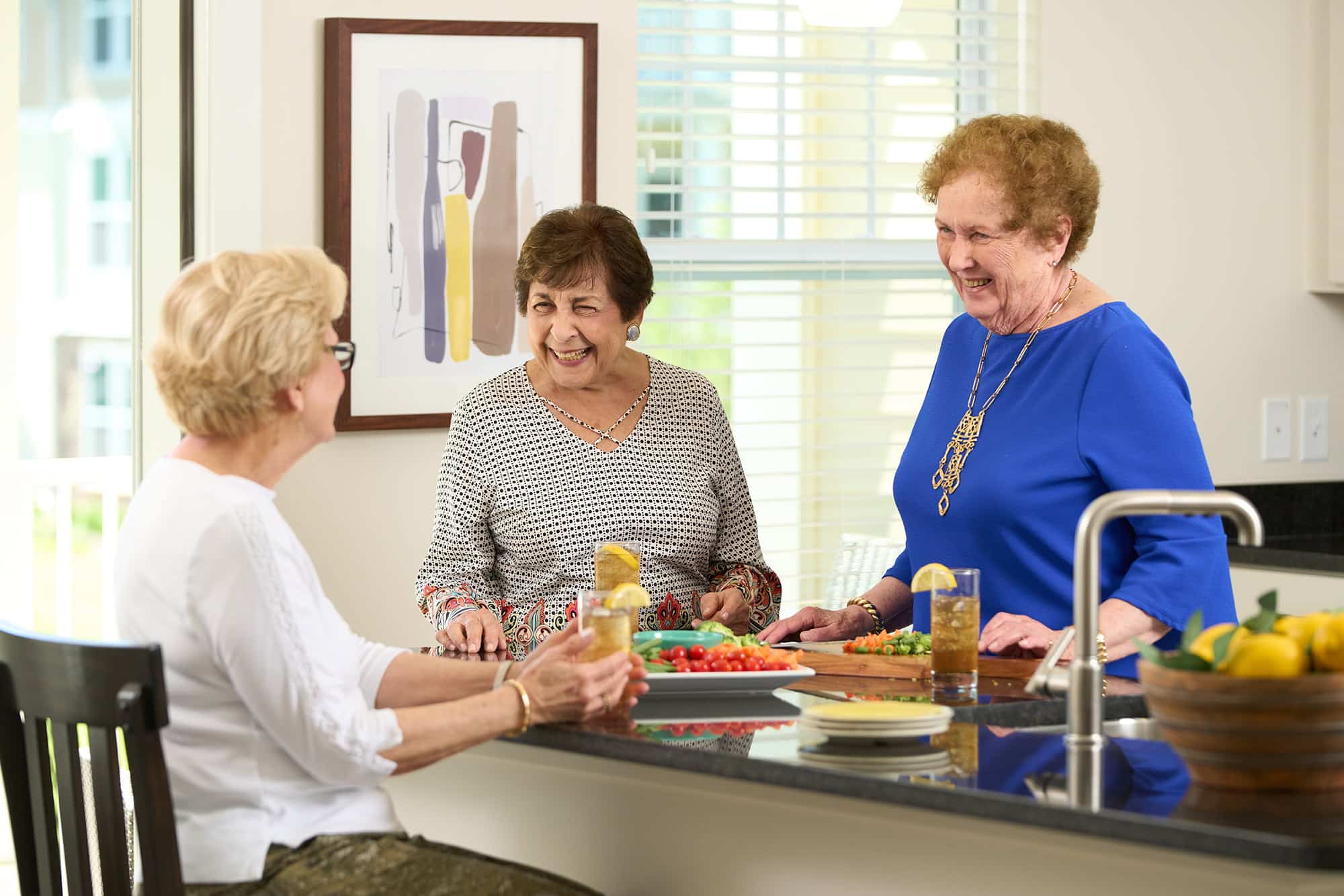 3 ladies at kitchen counter with vegys