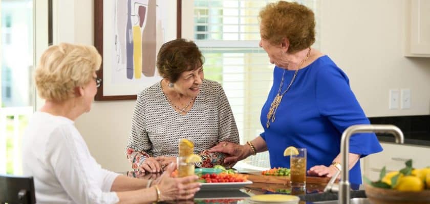 3 ladies sitting around kitchen island with ice tea