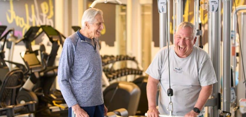 two men laughing and working out