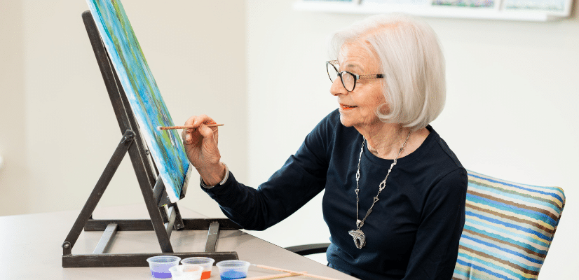 Woman at table at painting on canvas