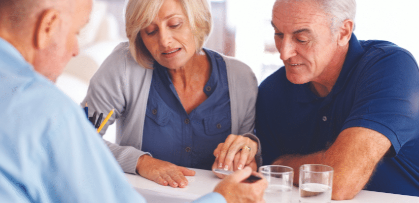 Couple looking over a document with a man